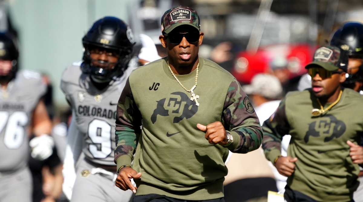 Colorado Buffaloes head coach Deion Sanders runs on to the field before a game against Arizona.